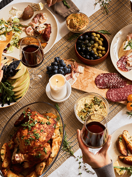 A top down shot of a dinner table loaded with food