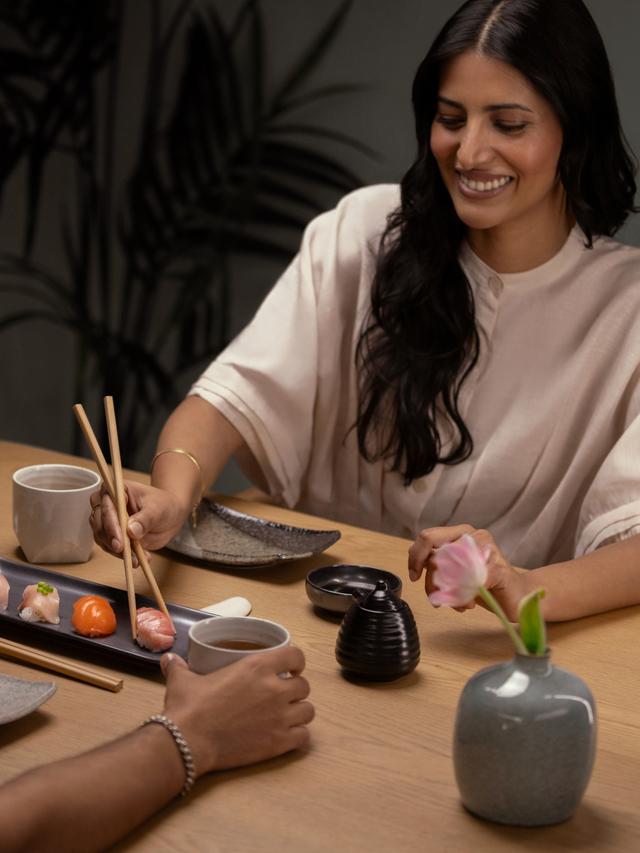 Woman eating sushi