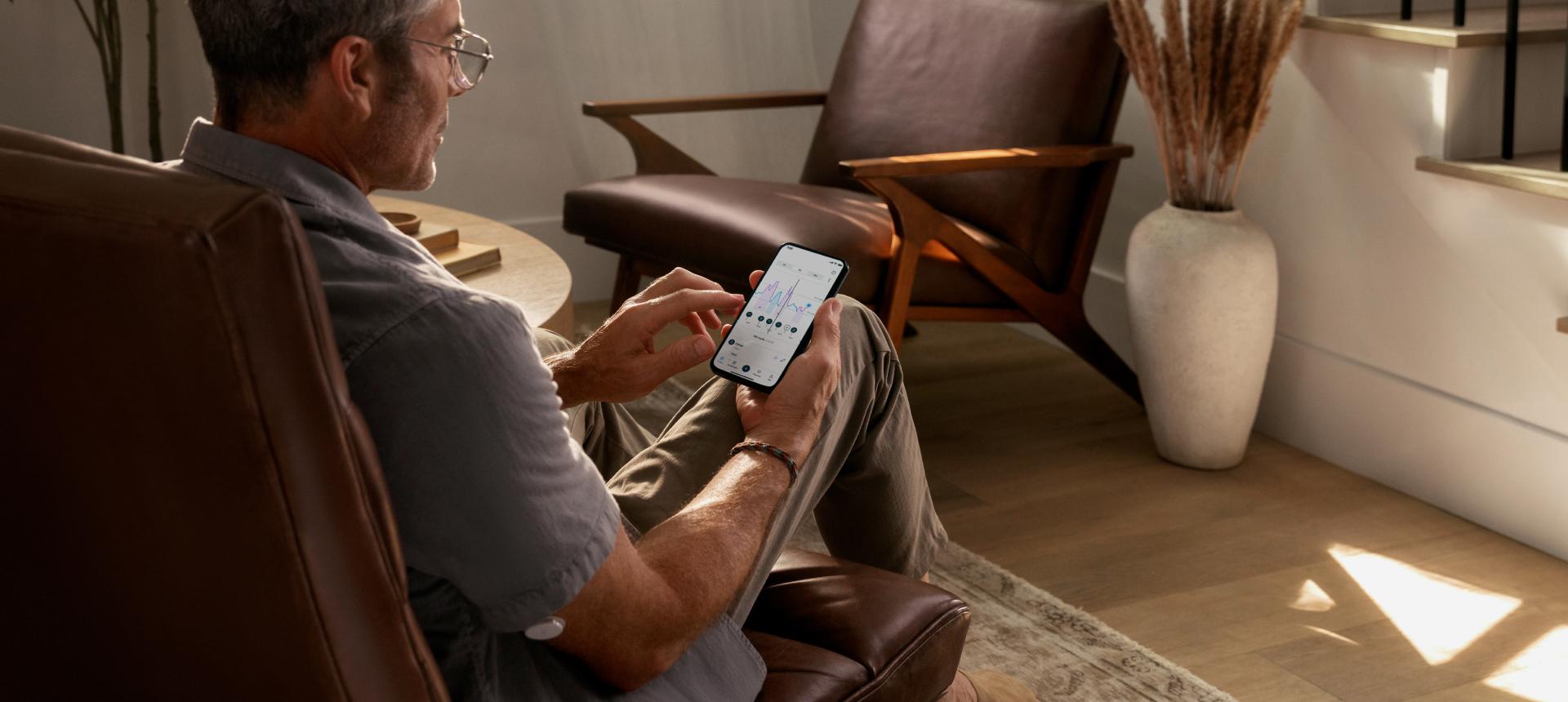 Person sitting on a chair looking at the Lingo app