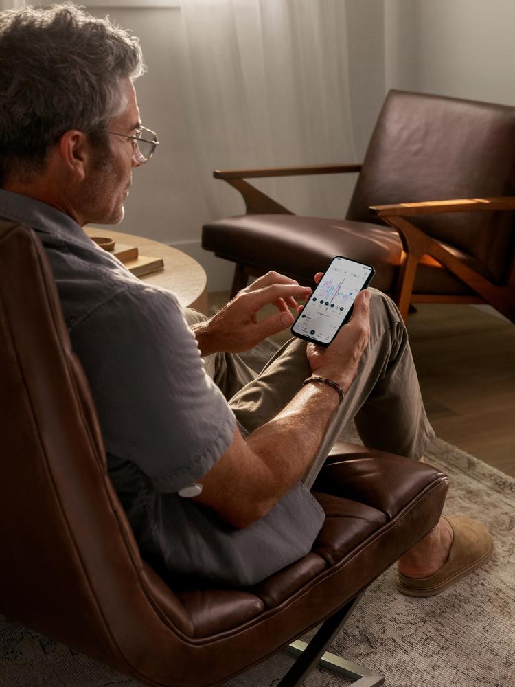 Man reading a Lingo app on iPhone