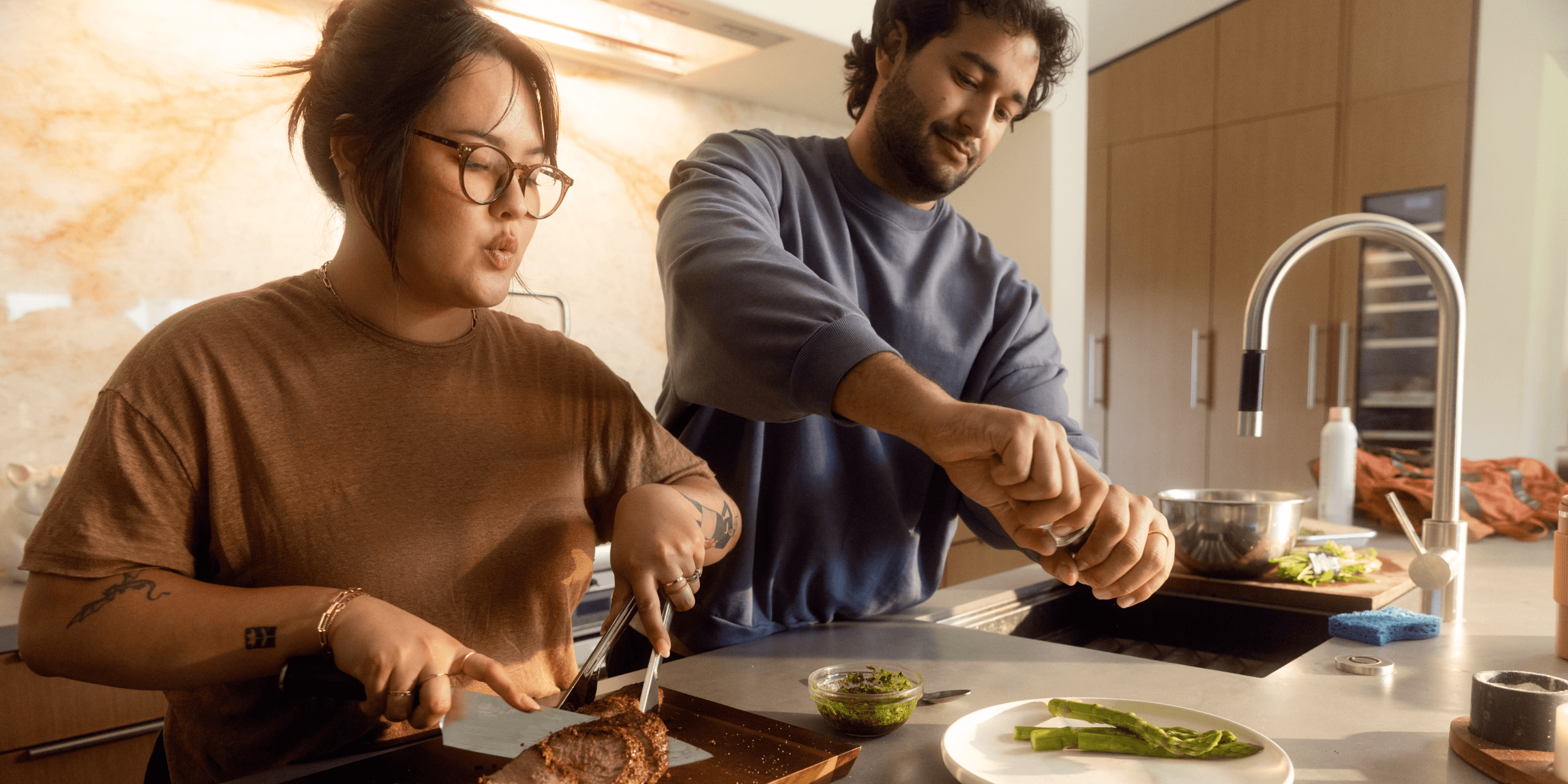 Two adults cooking healthy glucose-friendly meal in kitchen
