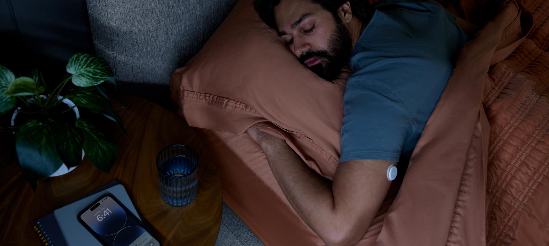 Male sleeping wearing a Lingo CGM