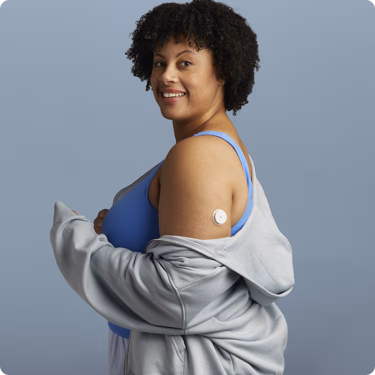 A woman wearing a Lingo Continuous Glucose Monitor