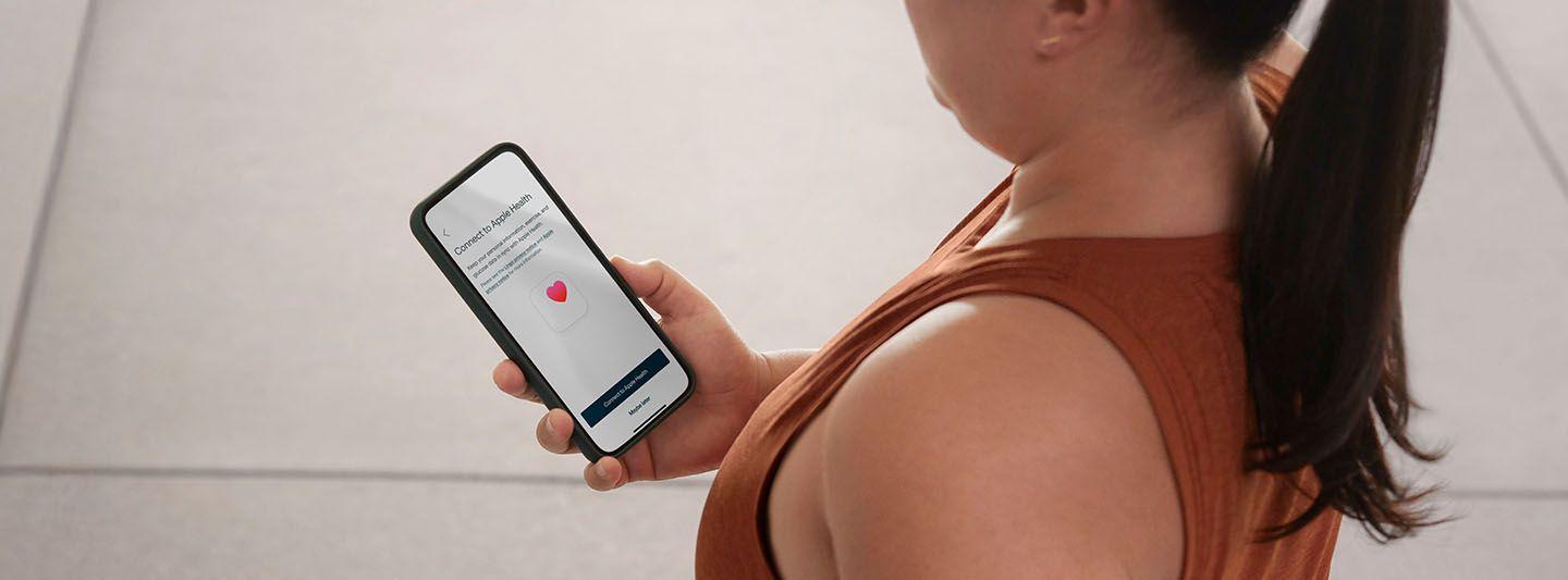 Woman looking at Lingo app on phone