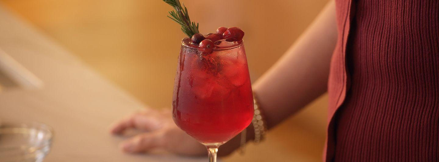 Tall glass of red-colored low-sugar alcoholic drink