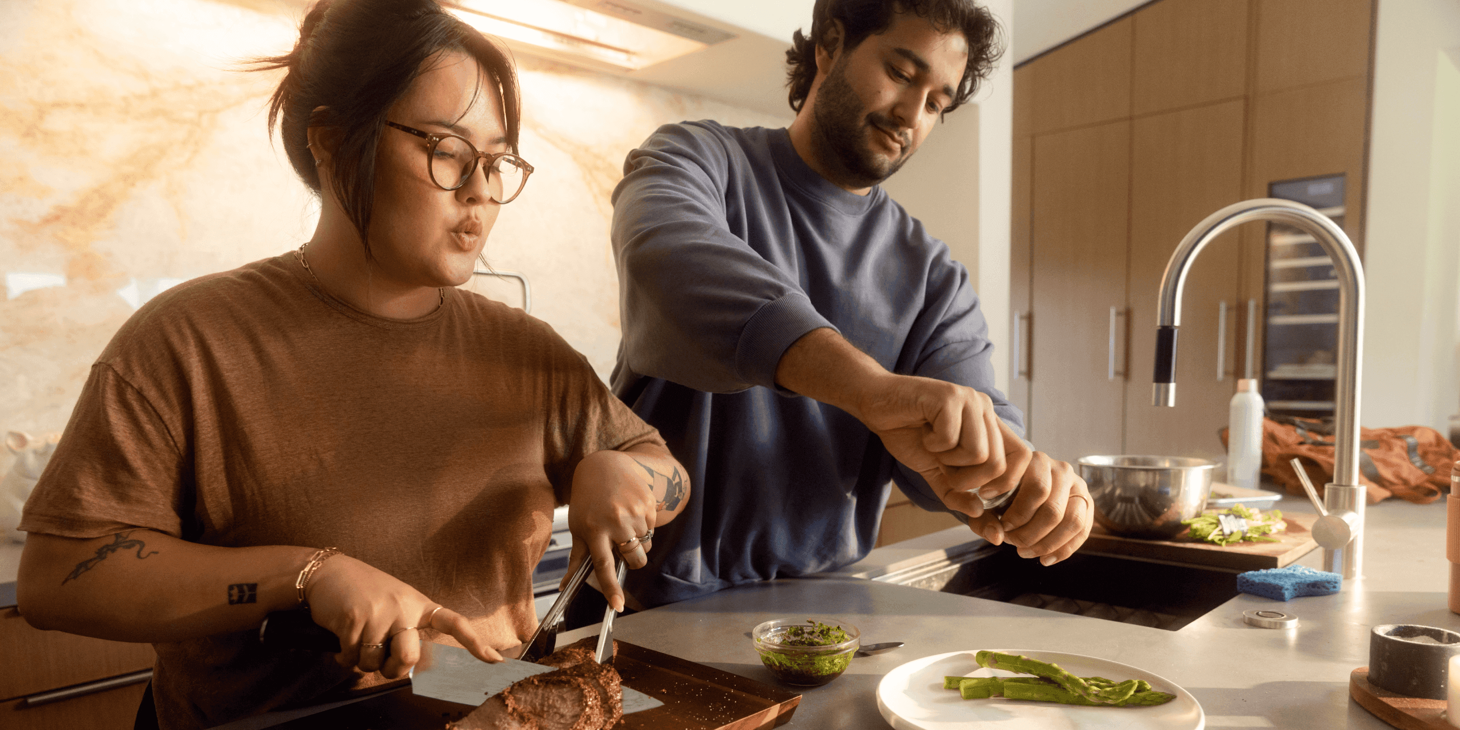 Two adults cooking healthy glucose-friendly meal in kitchen