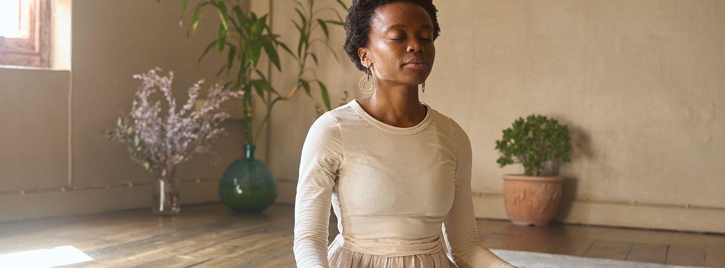 Woman managing stress using breathing exercises