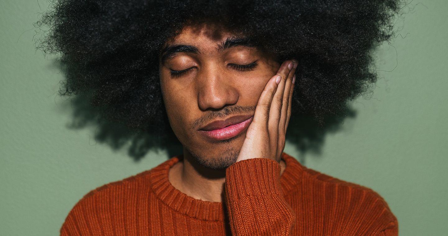 Person looking fatigued holding her forehead