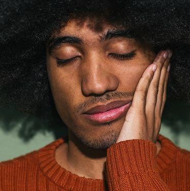 Person looking fatigued holding her forehead